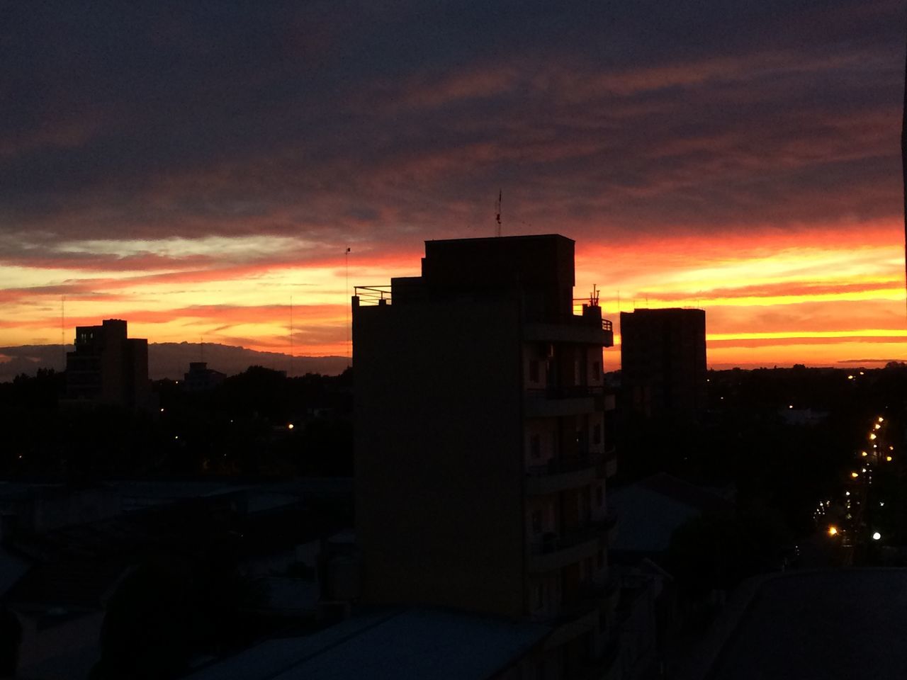 sunset, building exterior, architecture, built structure, silhouette, sky, city, orange color, cloud - sky, residential building, building, residential structure, dark, dramatic sky, cloud, dusk, cityscape, outdoors, house, tower