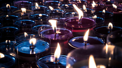 Illuminated tea light candles in temple