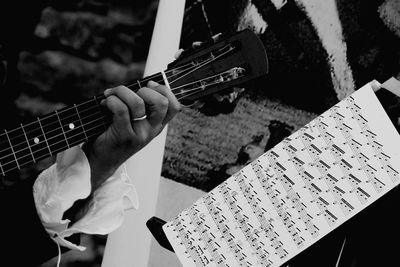 Close-up of hand playing guitar