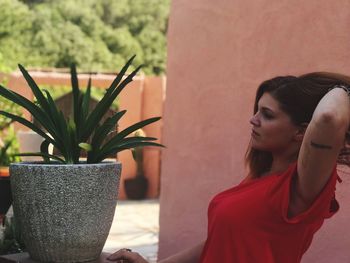 Woman looking at potted plant