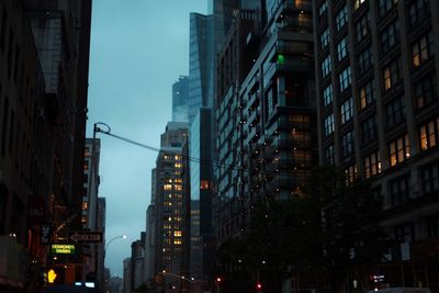 Low angle view of illuminated buildings against sky at night