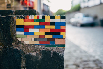 Wall on street repaired with plastic toy blocks