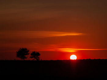 Scenic view of silhouette landscape against romantic sky at sunset