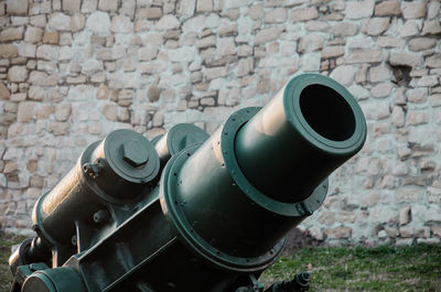 Close-up of cannon against wall