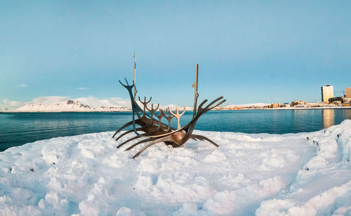 Scenic view of sea against sky during winter