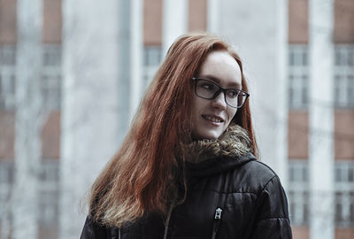 Portrait of beautiful young woman standing outdoors