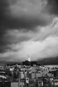 Buildings against cloudy sky