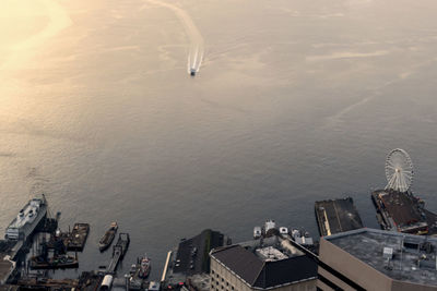 A ferry boat water tax coming into colman dock on the seattle waterfront at dusk.