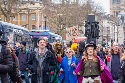 Group of people standing on street in city