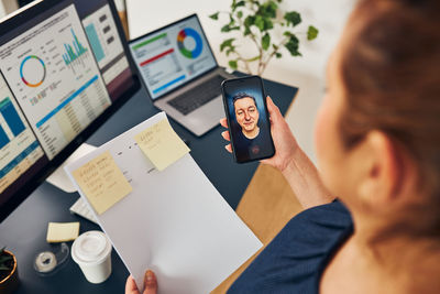 Midsection of woman using mobile phone