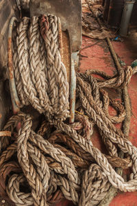 Dirty ship's rope uncoiled lying among the debris on board the shipwrecked ship. view from the ship