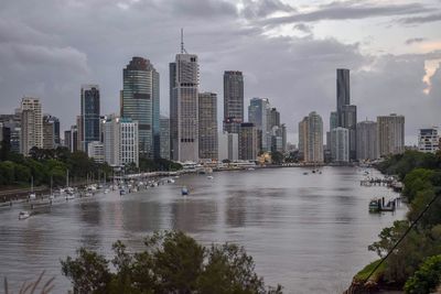 River by buildings against sky in city