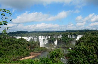 Scenic view of waterfall against sky