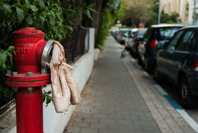 Red fire hydrant on footpath in city