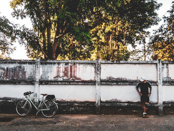 Rear view of man cycling on bicycle in city