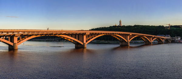 Kyiv metro bridge across the dnieper river on a sunny summer evening.