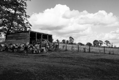 Barn on field against sky
