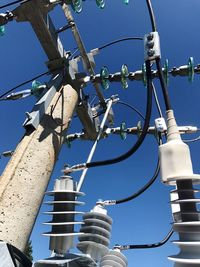 Low angle view of cables against clear blue sky