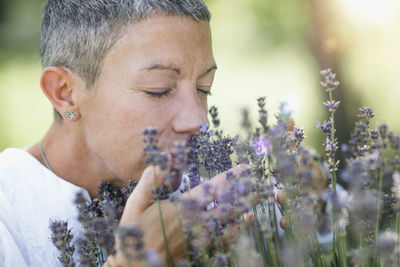 Woman smelling lavender flowers