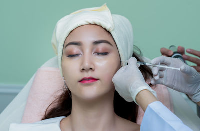 Close-up of woman receiving plastic surgery on face