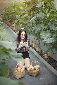 Portrait of smiling young woman sitting outdoors