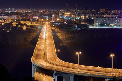 High angle view of illuminated buildings against sky at night