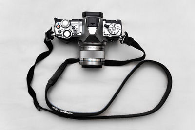 Close-up of camera on table against white background