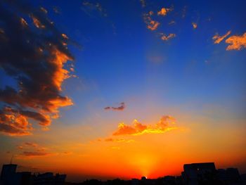 Low angle view of silhouette buildings against sky during sunset