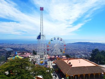 High angle view of ferris wheel against buildings