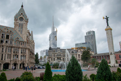 View of buildings against cloudy sky