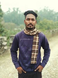 Portrait of young man standing outdoors