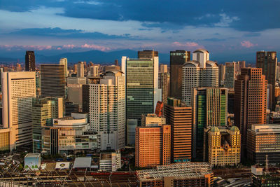 View of skyscrapers against cloudy sky