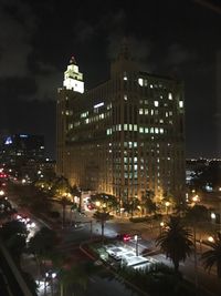 Illuminated buildings against sky at night