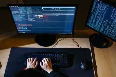 Hacker hands working on computer at office