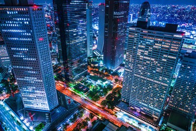 High angle view of illuminated buildings in city at night