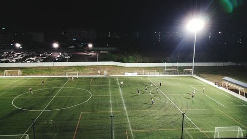 Illuminated lights on soccer field at night