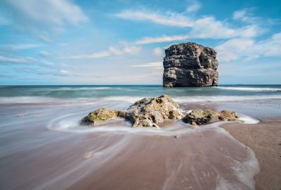 Scenic view of sea against cloudy sky