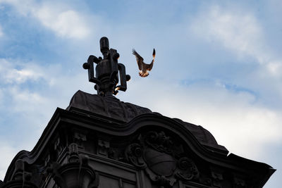 Low angle view of statue against sky