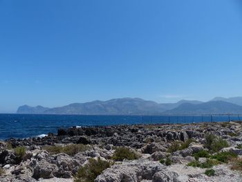 Scenic view of sea against clear blue sky