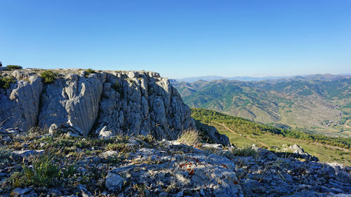 Scenic view of mountains against clear blue sky