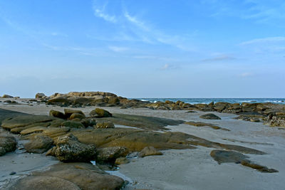 Rocks on beach against sky