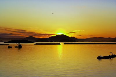 Scenic view of sea against orange sky