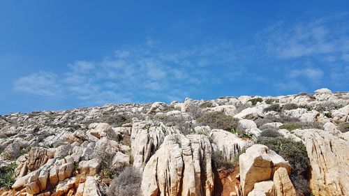 Low angle view of rock formations against sky