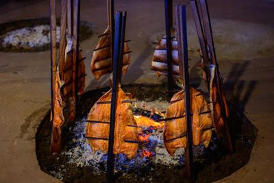 Close-up of salmon tied to stick at bonfire