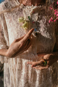 Cropped hands of a young woman holding an acrylic pendant