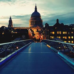 London millennium footbridge leading towards st paul cathedral against sky