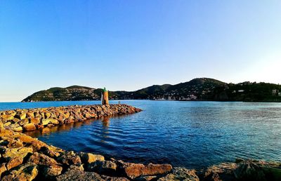 Scenic view of sea against clear blue sky