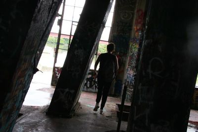 Man walking in abandoned building