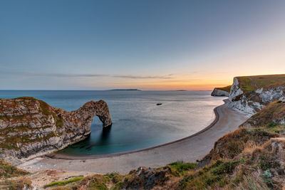 Durdle door at the jurassic coast in dorset, england, at sunset