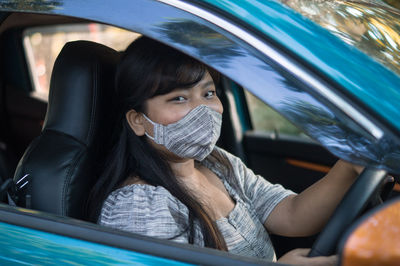 Portrait of woman sitting in car